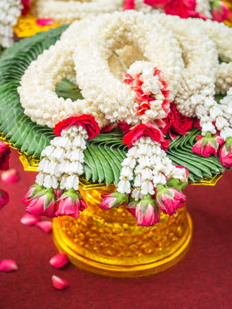 Thai garlands laid on the golden bowlの写真素材