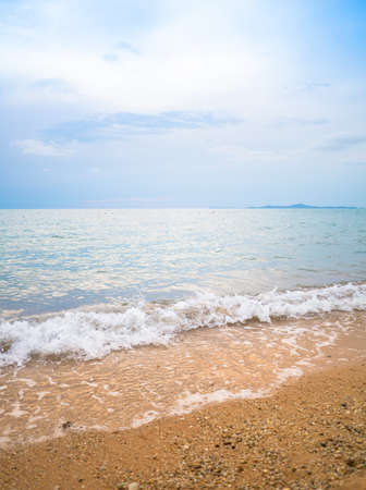 Clean and white wave on the beach along the clear blue sky. Remembrance of the last summer trip.の写真素材