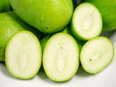 Fresh mangoes, cross section, isolated on whiteの写真素材