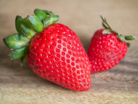 Fresh organic strawberry on wooden textured backgroundの写真素材
