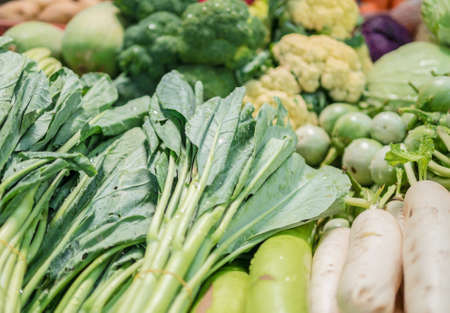 Mixed fresh vegetables laying to be sold in the market, shallow depth of fieldの写真素材