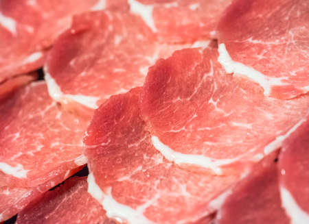 Raw meat slices ready to be cooked able to use as backgroundの写真素材