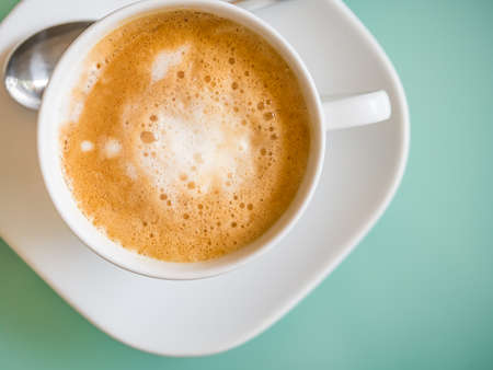 Hot latte coffee from top view in pastel color toneの写真素材