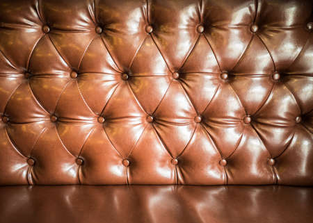 Brown buttons leather  sofa in low key able to use as backgroundの写真素材