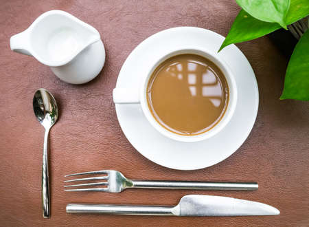 Cup of coffee with some culinary setup on leather backgroundの写真素材