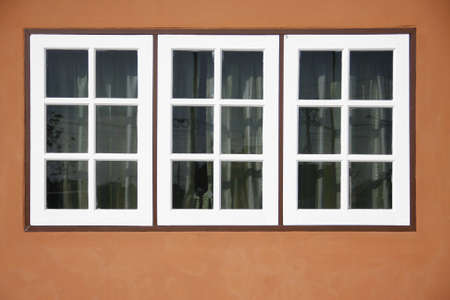 Three white panel front of brown house