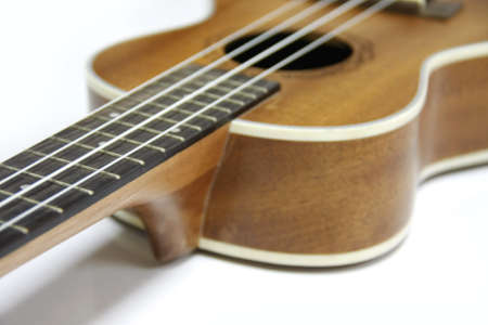 part and texture of brown wood ukulele on white backgroundの写真素材