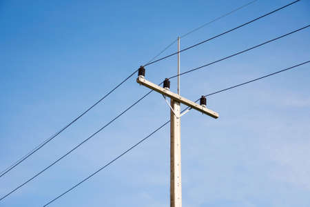 wire pole inside road withe blue sky on bright day