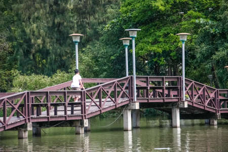 red wooden bridge over pond on park of silpakorn university, Nakhonpathomの写真素材