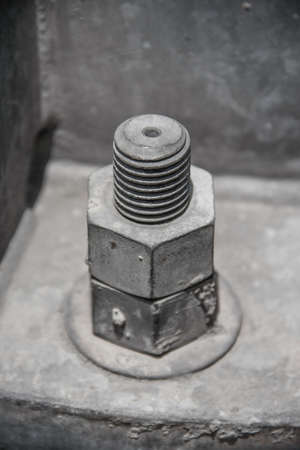 old dirty nuts with plate metal and protruding bolt for hold metal together and fixの写真素材