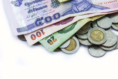 heap of coins with bank notes on white background