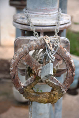 metal pipes locks old levers valves with chained and lockの写真素材
