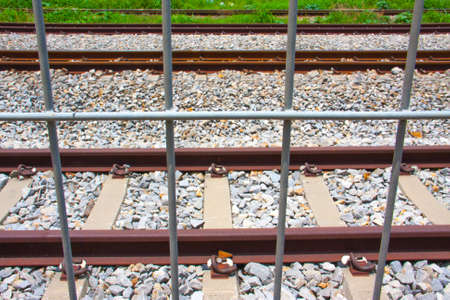 net metal fence of railway tracksの写真素材