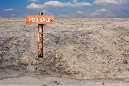 reclamation land area with wooden sign pole for saleの写真素材