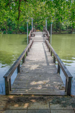 walkway wooden bridge over pond on park of silpakorn university, Nakhonpathomの写真素材
