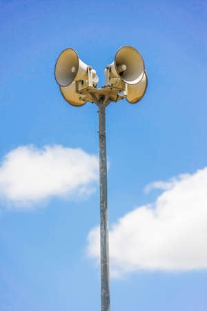 megaphone pole with blue sky and cloudsの写真素材