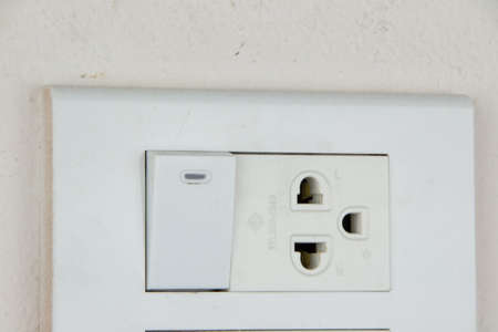 socket and switch on soft pink wall of roomの写真素材