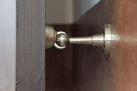 stainless magnetic door stop, hold doors open during, protect walls, door slam damageの写真素材