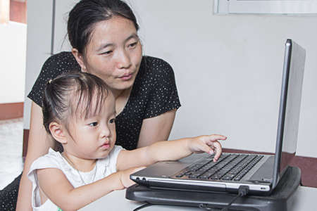 mother cares child surfing internet, family technologyの写真素材