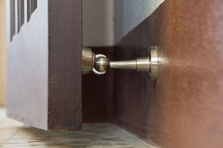 stainless magnetic door stop, hold doors open during, protect walls, door slam damageの写真素材