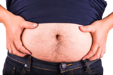 Man touching his fat belly on white backgroundの写真素材