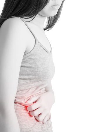 Stomachache in a woman isolated on white background.の写真素材
