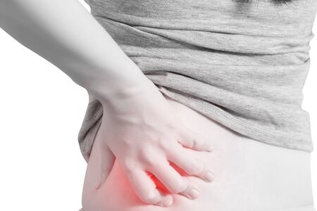 Backache or Painful waist in a woman isolated on white background.