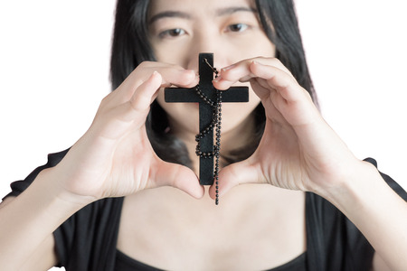 Hands of a asia woman Praying with Rosary, isolated on white background.の写真素材