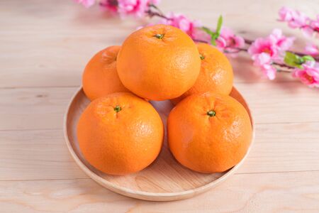 Top view accessories Chinese new year festival decorations.orange,leaf,wood dish,red packet,plum...