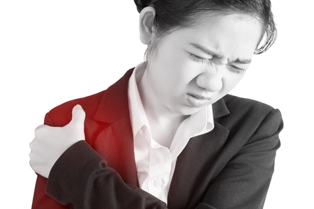 Painful shoulder in a businesswoman isolated on white background.の写真素材