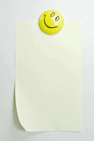 Yellow Note with a smiling magnetの写真素材