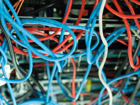 chaotic mess of network cables all tangled together