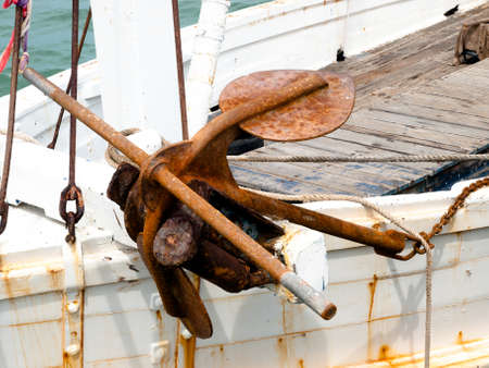 rusty anchor on a white shipの写真素材