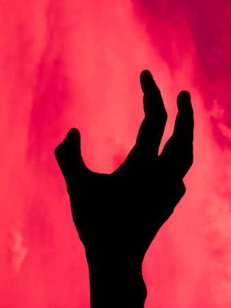 Abstract Black hands of death on red backgroundの写真素材