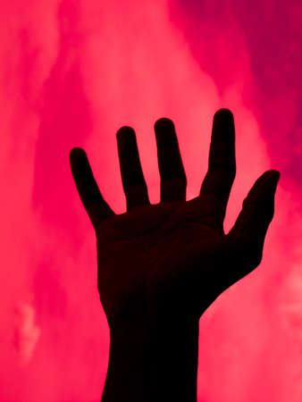 Abstract Black hands of death on red backgroundの写真素材
