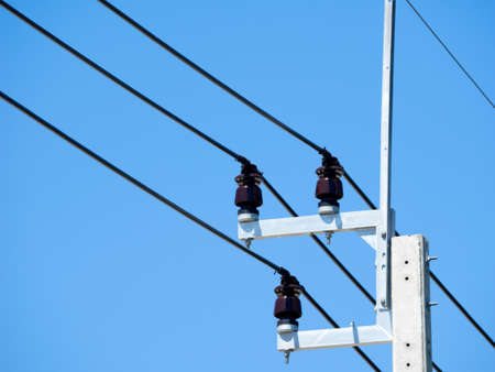 Electrical poles of high voltage in blue sky backgroundの写真素材