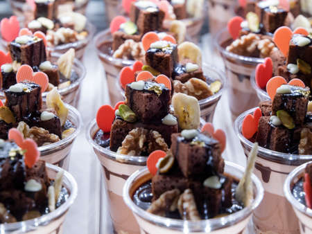 many sweet cupcakes with butter cream and candyの写真素材