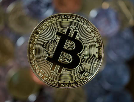 Bitcoin gold coin. Cryptocurrency concept over real currency coin