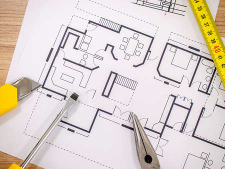 Home improvement concept - Blueprint paper with folding ruler, work tool on a wooden desk
