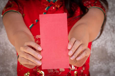 people hands giving red packet to younger in Chinese lunar new yearの写真素材