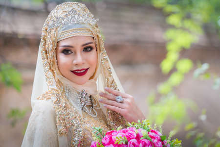 Portrait muslim bride posing in yellow dressingの写真素材