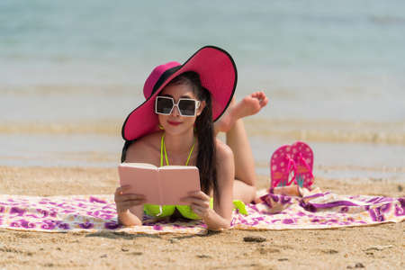 Portrait of woman posing outdoors at the sea beachの写真素材