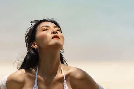 Portrait of woman posing outdoors at the sea beachの写真素材