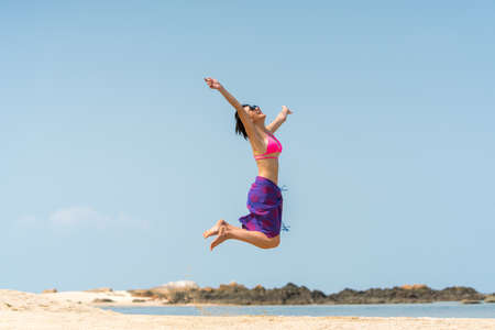 Portrait of woman posing outdoors at the sea beachの写真素材