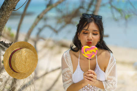Portrait of woman posing outdoors at the sea beachの写真素材