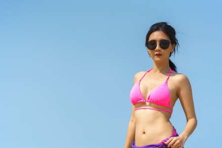 Portrait of woman posing outdoors at the sea beachの写真素材
