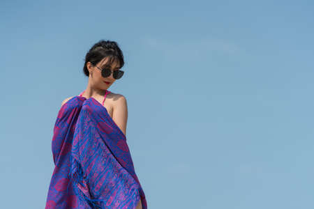 Portrait of thai woman posing outdoors at the sea beach