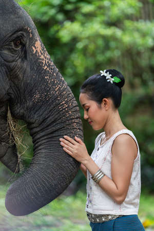Portrait of Thai Woman In Traditional Costume with elephantの写真素材