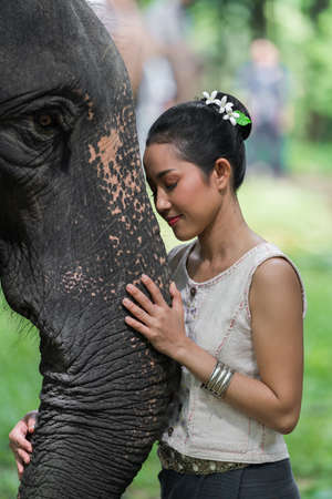 Portrait of Thai Woman In Traditional Costume with elephantの写真素材