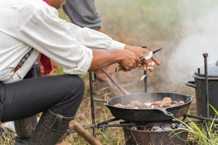 cowboy cooking food at camping conceptの写真素材
